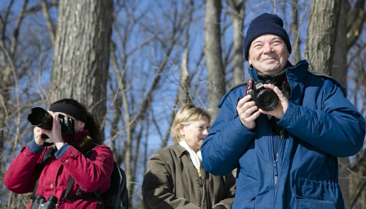 A group of photographers in the forest.