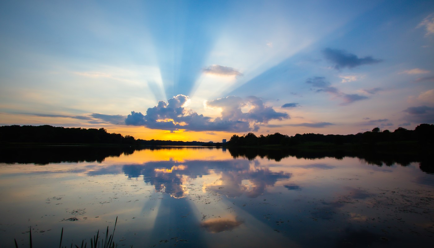 A stunning sunset above a peaceful lake.