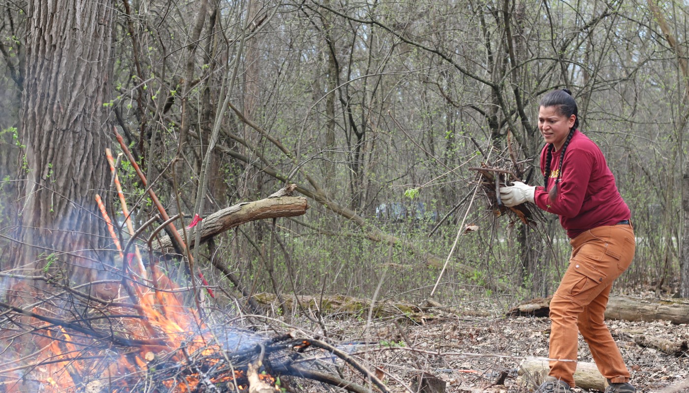 A person participating in brush burning activities.