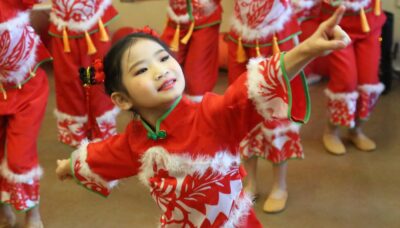 A group of children performing a dance at a Lunar New Year celebration.