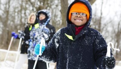 A group of children skiing together in the snow.