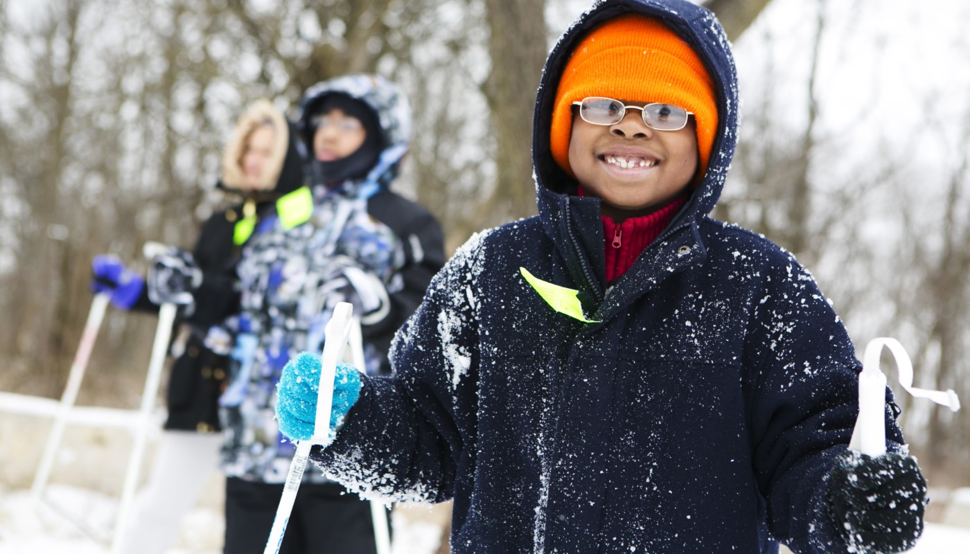 A group of children skiing together in the snow.