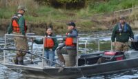 Staff pictured on a fishing boat outdoors.
