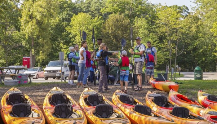 A group of people prepping for a paddle.