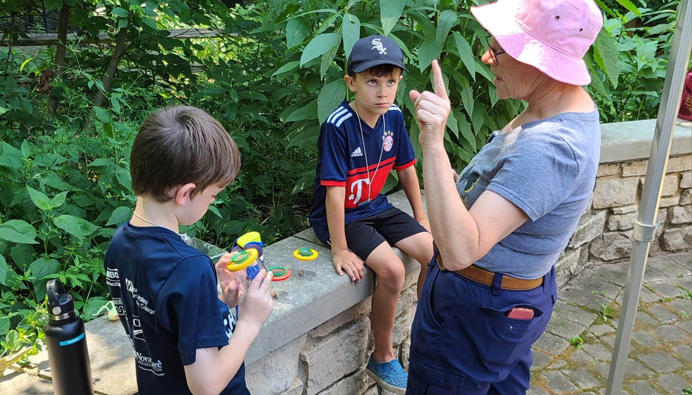 A person teaching children outdoors.