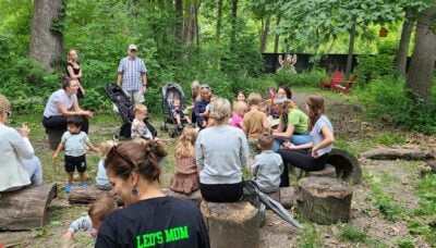 A group gathered outdoors for a storytelling program.