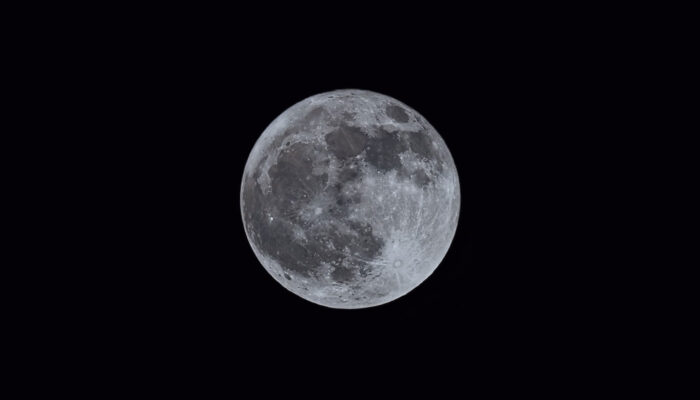A telescope photo of a full moon taken from the Palos Preserves.