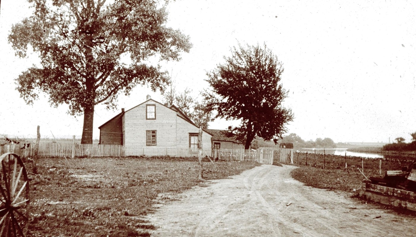 A vintage photograph of a farmhouse.
