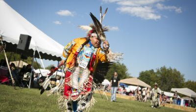 Traditional Native American dancing, food and vendors in an outdoor environment.
