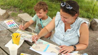 A group painting together outdoors.