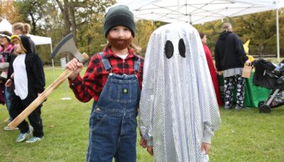 Children wearing Halloween costumes outdoors.