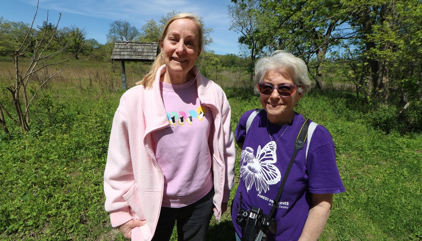 Two women standing in a field.